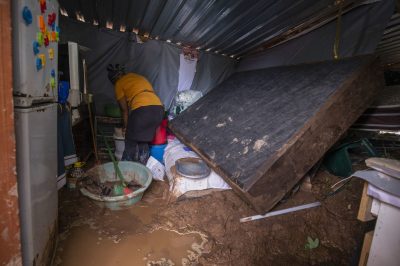 12 April 2022: eNkanini residents mop up after floods damages their homes in eNkhanini, Durban.