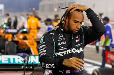 (FILES) In this file photo taken on November 29, 2020 Mercedes' British driver Lewis Hamilton steps out of his car after winning the Bahrain Formula One Grand Prix at the Bahrain International Circuit in the city of Sakhir on November 29, 2020. - World champion Lewis Hamilton has tested positive for coronavirus and will miss this weekend's Sakhir Grand Prix in Bahrain, Formula One's governing body FIA announced Tuesday. (Photo by HAMAD I MOHAMMED / POOL / AFP) (Photo by HAMAD I MOHAMMED/POOL/AFP via Getty Images)