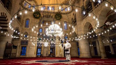 A government worker disinfects the Kılıç Ali Pasa mosque in Istanbul last week. Turkey is just one of a host of countries across the Muslim world where Friday prayers have been banned or curtailed to stem the spread of the coronavirus.