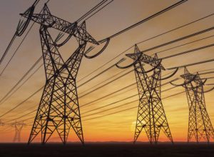 The silhouette of the high voltage power lines during sunset.