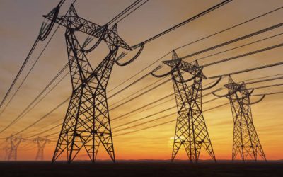 The silhouette of the high voltage power lines during sunset.