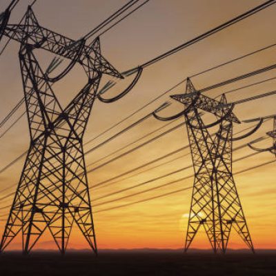 The silhouette of the high voltage power lines during sunset.